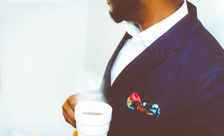 smartly dressed man with coffee
